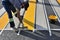 Moscow, Russia - Aug 21. 2023. worker applies yellow paint with spatula to the asphalt at pedestrian crossing in