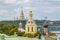 Moscow, Russia - August 13, 2019: Colored domes of orthodox churches against Moskva River and Lomonosov Moscow State University