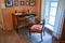 Moscow, Russia - August 30, 2016 - Cabinet of 18th century in russian antique mansion with wood table, armchair and window