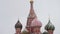 MOSCOW, RUSSIA - DECEMBER, 2018: Tilt up of St. Basil`s Cathedral domes on the background of grey sky