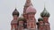 MOSCOW, RUSSIA - DECEMBER, 2018: Tilt up of St. Basil`s Cathedral in snow on the background of grey sky