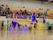 Moscow, Russia - December 22, 2019: Girls cheerleaders perform acrobatic jump trick, in motion on background of stands