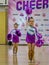 Moscow, Russia - December 22, 2019: little cheerleader girls from support team in purple leotards dance with hands up