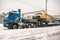 MOSCOW, RUSSIA - FEBRUARY 05, 2018: Specialised powerful lorry transports yellow wheel excavator Hyundai on a lowboy trailer.