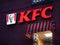 Moscow, Russia - January 17, 2020: KFC logo with red lights on wall of house in evening. Luminous windows with visors made of