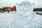 MOSCOW, RUSSIA - January 2, 2016. sculpture of monkey carved from ice on the background of snow-covered winter Park