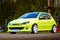 Moscow, Russia - July 06, 2019: Bright green, Peugeot 206 tuned with white rims and lowered suspension. It is in the parking lot.