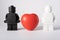 Moscow, Russia - July 26, 2022. White and black lego figures with a red heart between them