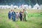 MOSCOW,RUSSIA-June 06,2016: Beautiful peasant women going over grass field in romanian traditional costume