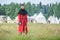 MOSCOW,RUSSIA-June 06,2016: Man in ancient merchant costume stands on green field of grass