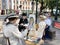 Moscow, Russia, June. 20, 2019. Woman in retro dress drawing a portrait on the square at the Peter`s gate Petrovskie Gate in Mo