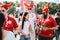 MOSCOW, RUSSIA - JUNE 2018: Danish fans wearing Viking helmets painted in national colors with a Russian girl in the fan zone duri