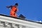 Moscow, Russia, March, 06, 2018. The worker of municipal service clear a roof from the accumulated snow in Moscow