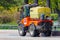 Moscow, Russia - May 01, 2019: Small orange municipal sprinkler truck on street in Moscow historical center at sunny spring