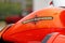 Moscow, Russia - May 04, 2019: Bright orange fuel tank with emblem of Harley Davidson motorcycles closeup. Moto festival