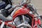 Moscow, Russia - May 04, 2019: Chrome engine and bright red fuel tank with Harley Davidson motorcycles emblem closeup. Moto