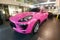 Moscow, Russia - May 09, 2019: Pink Porsche Macan in showroom of dealer center. Car is wrapped in colored protective film. Fisheye