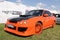 Moscow, Russia - May 25, 2019: A bright orange Subaru WRX STI tuned in a body kit with orange alloy wheels stands on the street