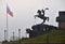 Moscow, Russia, November 02, 2021:   Statue of St. George Victorious at foot of main Victory obelisk  and flag of Russian Federati