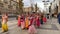 Moscow, Russia - November 12, 2019: Hari Krishna people, women in colorful sari walk along the street, sing and dance