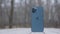 MOSCOW, RUSSIA-NOVEMBER, 2020: Back of new iPhone. Action. New stylish iPhone stands on background of park and snow. New