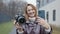 Moscow, Russia-November, 2020: Camera and iPhone comparison. Action. Woman compares professional camera and new iPhone