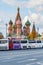 Moscow, Russia - October 08, 2019: Parked tourist buses against Saint Basil Cathedral on Red square in sunny autumn evening. St