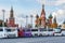 Moscow, Russia - October 08, 2019: Tourist buses parked on Red square in sunny autumn evening. Red square is a popular touristic