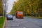 Moscow. Russia. October 11, 2020. An orange heavy truck washes autumn leaves off the asphalt street