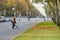 Moscow. Russia. October 11, 2020 A woman utility worker uses a blower to remove fallen leaves on a city street.