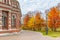 Moscow, Russia - October 16, 2019: Autumn in Tsaritsyno Park in Moscow. Trees with bright colored leaves against facade of