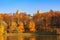 Moscow, Russia - October 17, 2018: Grand palace on a background of pond and trees with golden leaves on shore in Tsaritsyno park