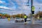 Moscow. Russia. October 19, 2020 Two workers in yellow uniforms assemble a road sign on a lamppost on a city street