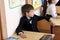 Moscow, Russia - September 1, 2017: Schoolboy, pupil sitting at the desk in class at school, traditional learning, offline