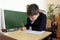 Moscow, Russia - September 1, 2017: Schoolboy, pupil sitting at the desk in class at school, traditional learning, offline