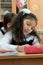 Moscow, Russia - September 1, 2017: Schoolgirls sitting at the desk in class at school, traditional learning, offline education