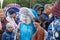 Moscow, Russia - September 14, 2019: A clown, mime, woman in carnival costume standing in a crowd of people and posing