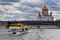 Moscow, Russia - September 30, 2018: Pleasure boats floating on Moskva river against Cathedral of Christ the Saviour in cloudy