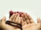 Moslem man praying using wooden beads