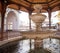 Mosque with fountain in front, with large glass building. High quality photo