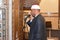 A mosque Imam preacher muezzin in front of the microphone reciting Adhan Azan or calling loudly for the prayer