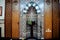 A mosque from inside with Islamic decorative style, mosque Mihrab or niche with a Quran put on a wooden stand