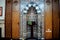 A mosque from inside with Islamic decorative style, mosque Mihrab or niche with a Quran put on a wooden stand and a microphone