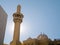 Mosque with minaret against the sun