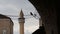 Mosque Minaret Through Arch With Black Bird On Power Line