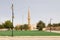 Mosque with minaret in a small place in Saudi Arabia. The lawn in the foreground is artificial turf so that the place looks nicer
