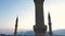 Mosque minarets on evening sky background and mountains silhouettes.