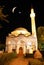 Mosque in night with crescent and star above