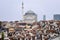 The mosque rises above brown roofs in Istanbul, Turkey