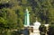 The mosque tower amidst shady trees with dense green leaves